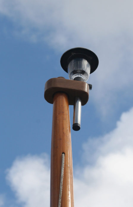 A piece of oak with a large tapered hole for the mast and a 1" hole for the Premium RailLight serves as a way to use it as an all-around or anchor light.