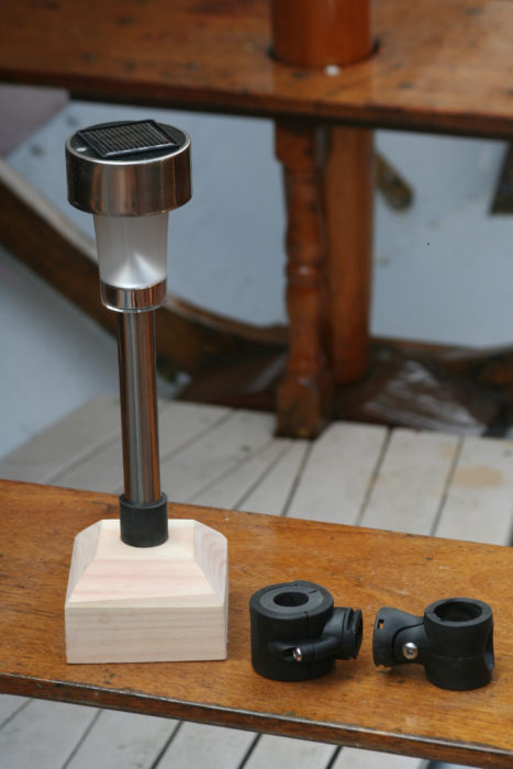 The Mini RailLight has hardware for attaching it to a stanchion or rail. The wooden base is homemade.
