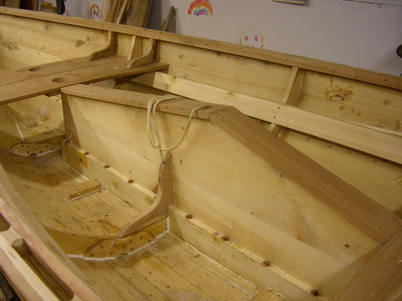 The centerboard trunk has a black cherry (Prunus serotina) cap, white pine (Pinus strobus) sides, tamarack bedlog, and apple (Malus spp.) knees. The bedlog is affixed to bottom with silicon-bronze carriage bolts.