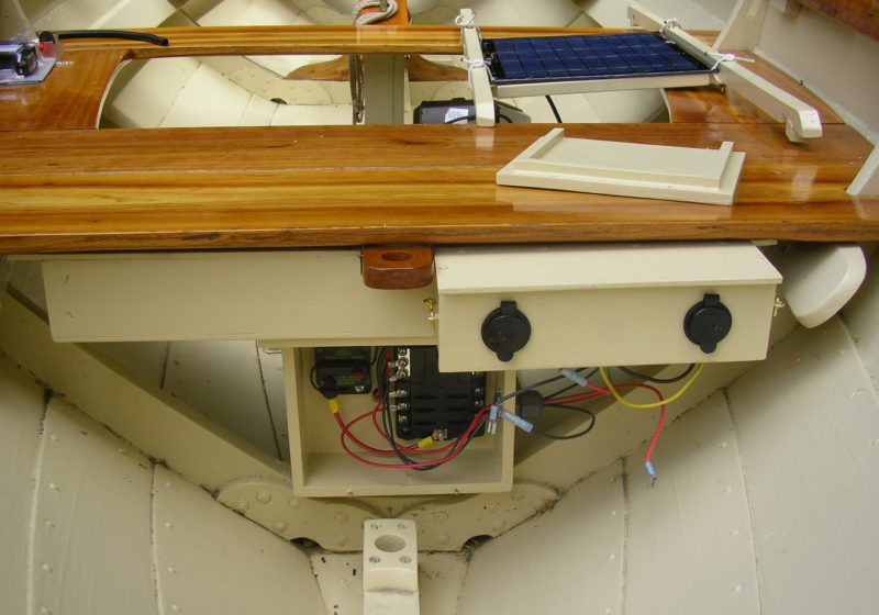 NONA BELLE's electrical system conceal most of its elements under the aft thwart and behind sealed covers. 