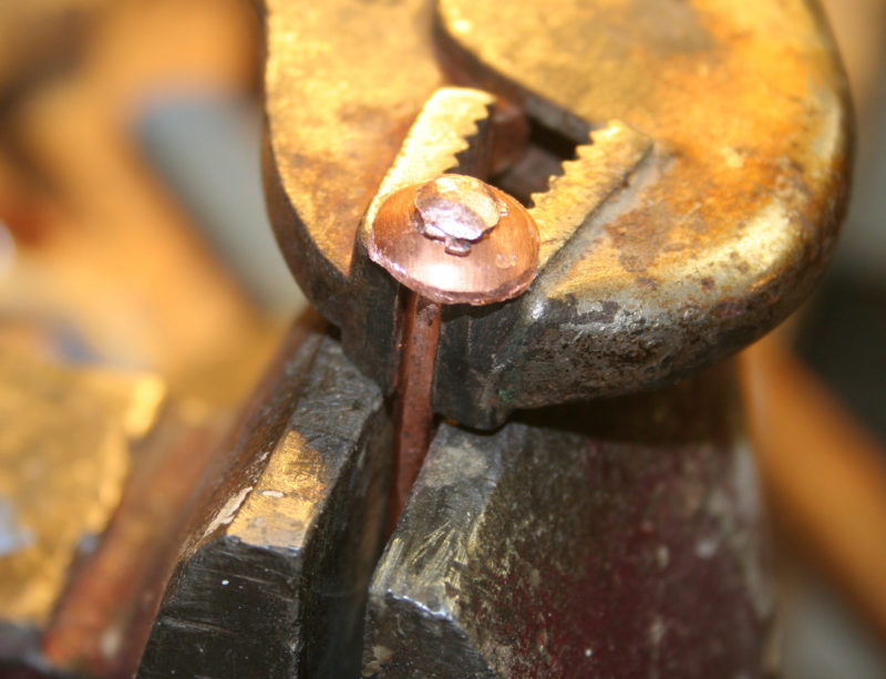Fixing a rove on one end of the rivet gives it an easily made head. Vice Grips keep the rivet shank from slipping during the peening.