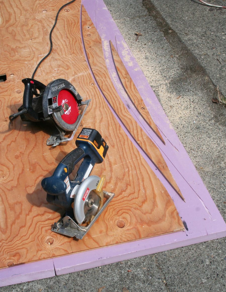Two circular saws and the curves they cut through common 3/8" CD plywood: The smaller blade of the cordless saw made the cut at right with a tighter radius.