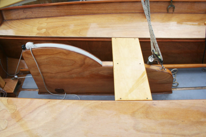Lines for raising and lowering the centerboard lead aft within easy reach of the helmsman.