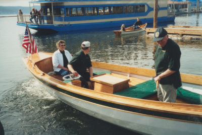 Rann backs the ELSIE MAE from the ramp with his mother, ELsie Mae, and Art Arpin aboard. Rann's daughter Heidi, aboard his ARCUS with her fiancé Sean, records the moment.