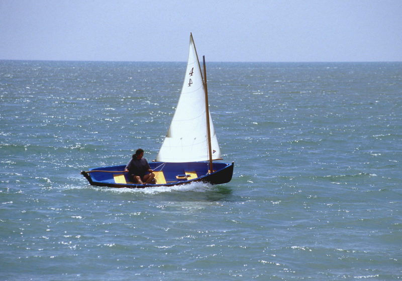 September, 1997. We launched the skiff at Seaford Beach in East Sussex. It was an exhilarating first sail. I sat in the bottom of the boat, as the designer had recommended, to keep my weight low. The first outing couldn't have been better—apart from nearly breaking a friend's leg when a big wave dumped the skiff in his lap.