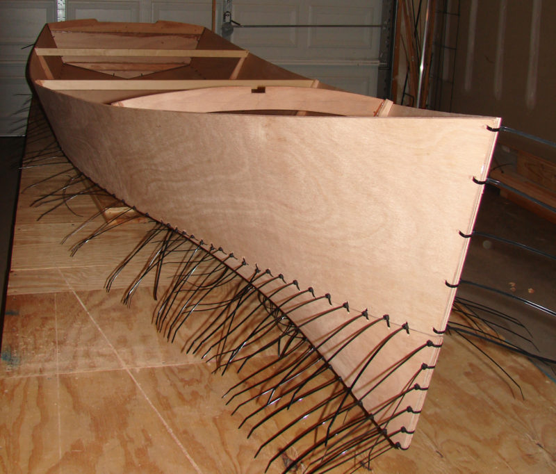 The bottom panels have quite a bit of twist in them, but good marine plywood will take the strain and provide fair and symmetrical curves. Cable ties rather than copper wire held the panels together until epoxy bonded the joints.