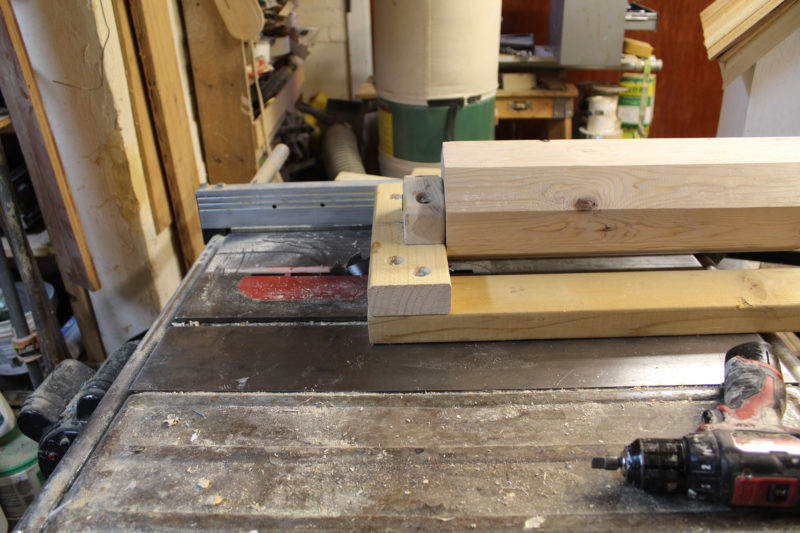 The eight-sided block could be installed in the frame and rotated over the table saw. With the blade set to take a light cut and a cordless drill connected to the axle, rounding could begin.
