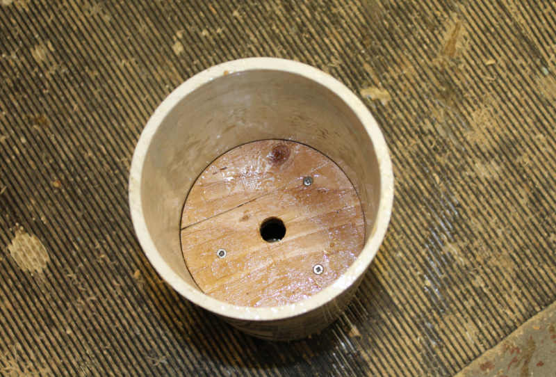 Two of the disks, joined with screws and epoxy, wee tapped down to the middle of the pipe.