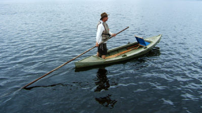 Tom Shepard poles a railbird skiff in the shallow waters of the Delaware River basin. The skiff is in the collection of Independence Seaport Museum in Philadelphia, Pennsylvania.