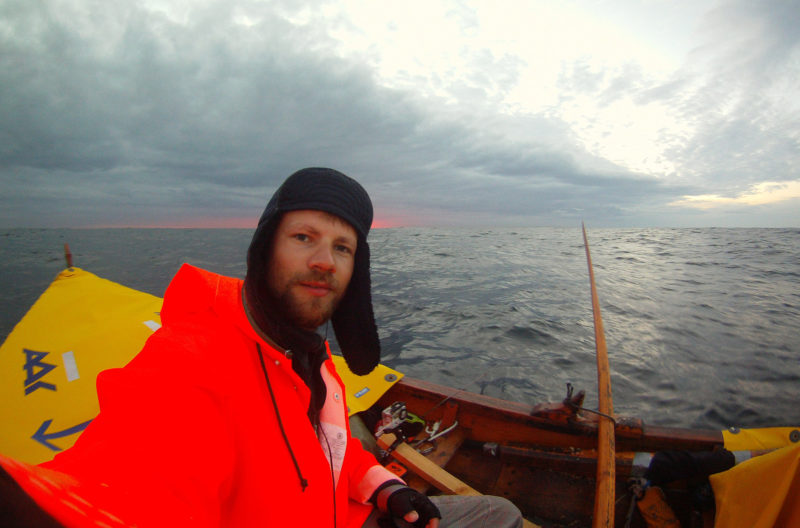 For the first days of the trip the sea was quite flat and made the rowing easy. Here the sun has just gone down, and Henrik is preparing for the night watch.