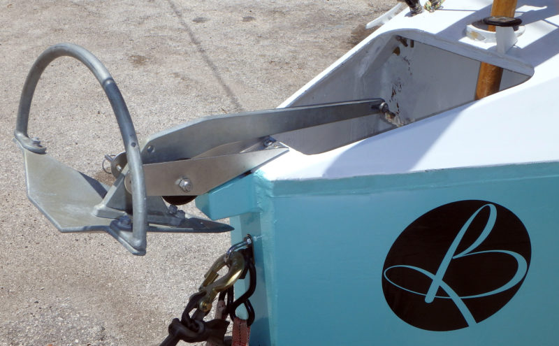 The anchor here is secured to a bow roller, but the well in the bow has room for it as well as the rode and chain. The well has a canted bottom and a scupper to drain water overboard.