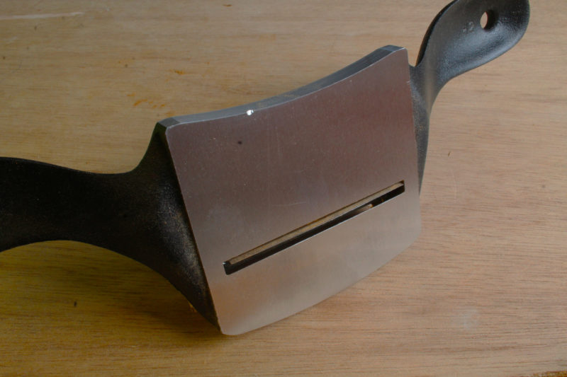 The bottom of the scraper is machined smooth and flat. The bright spot on the upward edge is a dent that was the only damage to dropping the tool in a concrete floor. The ding may have been caused by another tool the fell off a work table at the same time. Both survived without breaking.