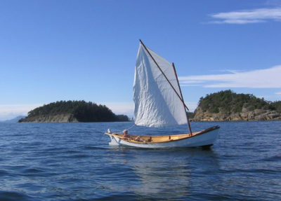 The loose-footed sprit sail makes sailing about as simple as it gets. Light summer breezes make for unhurried passages between islands.