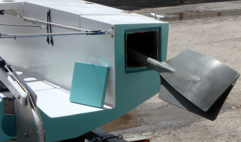 When the oars are not needed they can be stowed out of the way under the starboard deck. The cover for the access hatch is retained by an internal bungee cord.