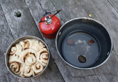 These peanut butter-chocolate rolls were baked using a pot-in-pot method. Three rocks in the larger put elevate the smaller pot to keep boiling water under the smaller pot. Not shown is the pot lid. The rolls aren't browned, but they're fully cooked.