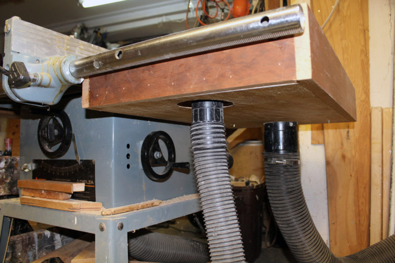 The dust collector is hooked up to the back of the downdraft table, the shop vacuum at the front. The shop vacuum is used if the downdraft table is removed for work outside of the shop table; its hole is plugged when the dust collector is in use.