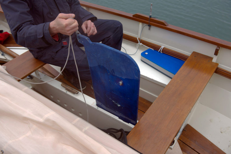 The centerboard drops into the trunk like a daggerboard, but once it is in place it pivots on a short pin that's embedded in the board.