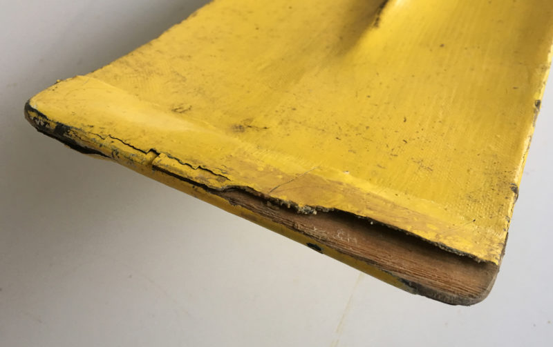 Although this blade was protected by a strip of hardwood glued in place and covered with fiberglass, the wear and tear of cruising still took its toll.