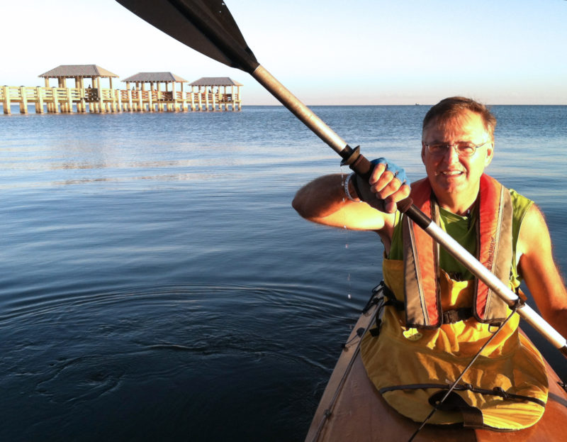 As approaching evening tinges the horizon with gold, Gene enjoys a final paddle. We had reached the Gulf of Mexico.
