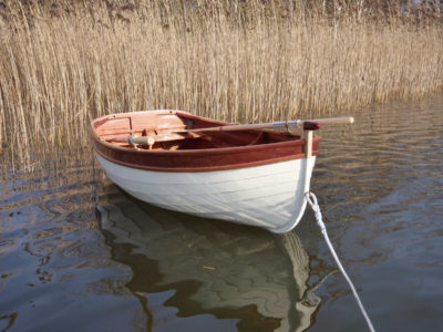 The dinghy sits lightly on the water and has enough volume to carry a complement of three.