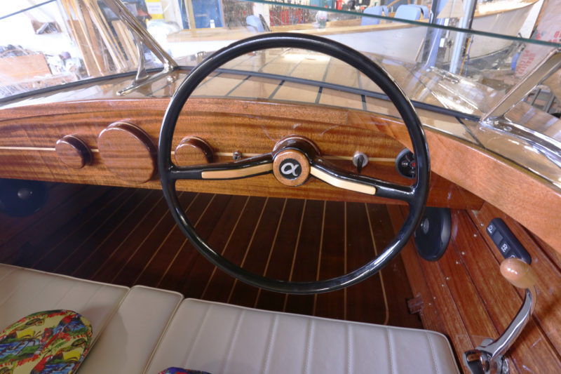 The wheel was originally manufactured for a Volkswagen. The dash is not yet finished, with gauges yet to be installed in the three wooden disks. 