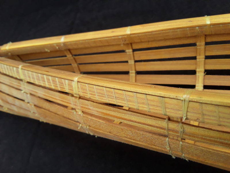 The three-piece gunwale, lashed together, caps the frame heads.