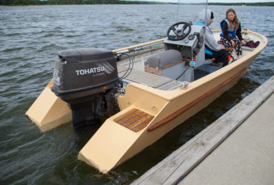 The tops of the extensions, squared off inside of the diagonal side panels, serve as steps for climbing aboard over the stern. The bright finished squares of decking are hatch covers.