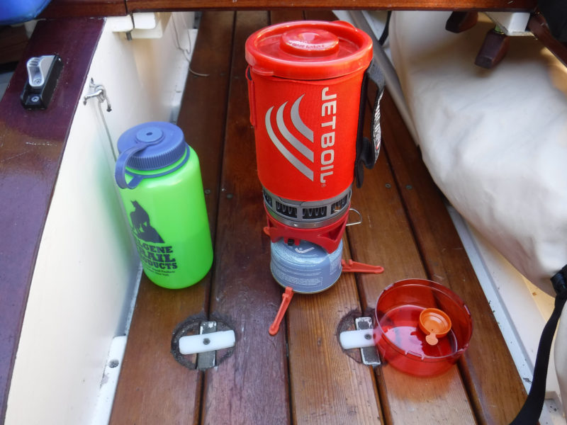 With the pot locked on the stove and a folding tripod base clipped to the fuel tank, the Jetboil system behaves it self while cooking at anchor with the boat rocking.