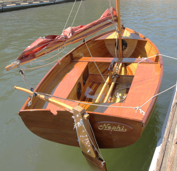 A loop of bungee holds the kick-up rudder blade down but lets it pivot over obstructions. A cord on the back side of the rudder stock runs through a shackle to make it easier to pull the blade up when approaching a beach. The sculling notch is offset to allow sculling while the rudder is in place.
