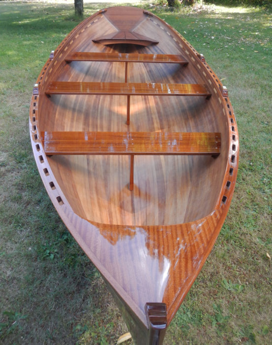 The strips in the bottom of the hull run parallel to the keel; those forming the topside are parallel to the sheer. The transition is at the turn of the bilge.