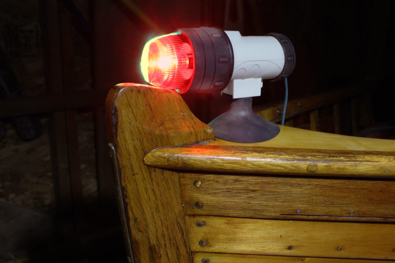 This suction-cup version of the bow light hold well to the arched but smooth varnished surface of this breasthook. A tether secured to the treaded insert at the back provides security if the suction cup loses its grip. In testing, this light was left on for 80 continuous hours. At the end of that run, the intensity of the light had grown dim. At 72 hours it was still clearly visible at 1/4 mile.