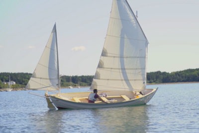 Man Sails Caledonia Yawl on Sunny Day