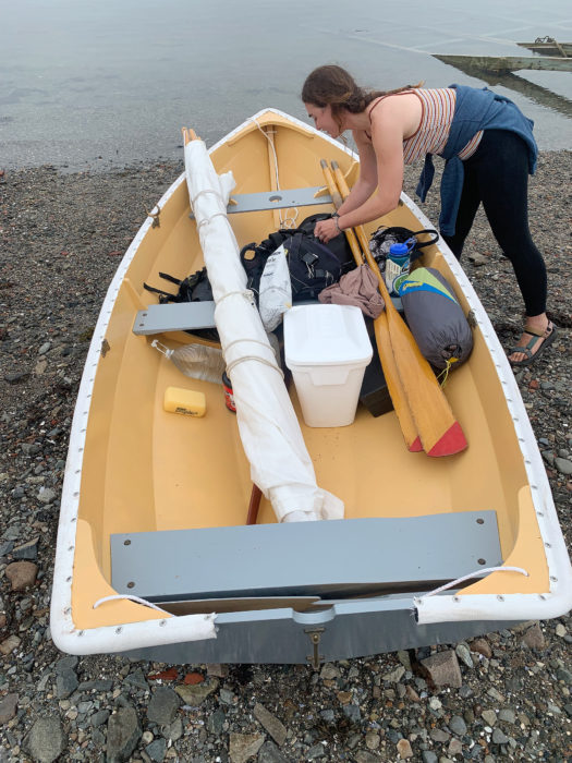 Delaney packs the shellback dinghy with oars, a sail, a foam cooler, life jackets, tent, and food.