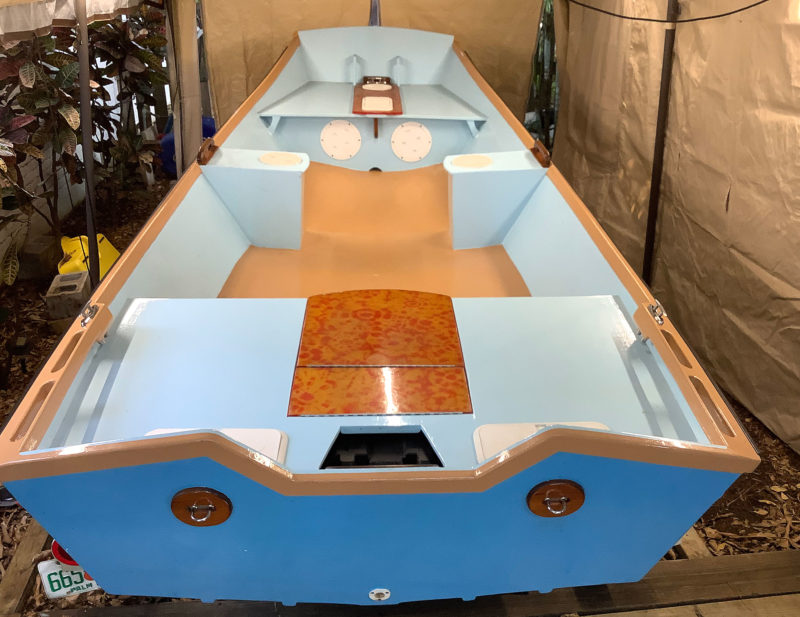 The teak rails were painted over in a beige/orange color. The boat's interior is light blue and the outer hull is electric blue. 