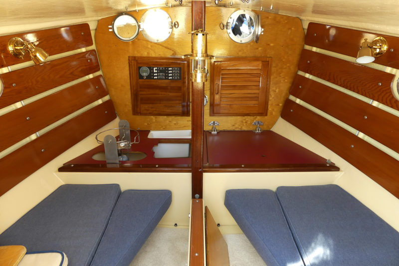 It's snug, but the Shrimper's interior has two sets of cushions (port and starboard) that can be used for seating or sleeping. There is a gimbaled burner in the foremost portion of the port side and a small icebox to starboard.