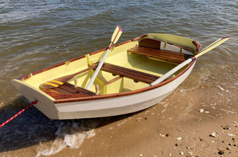 The nutshell looks very tidy with her oars, rudder, daggerboard, and spare paddle tucked away.