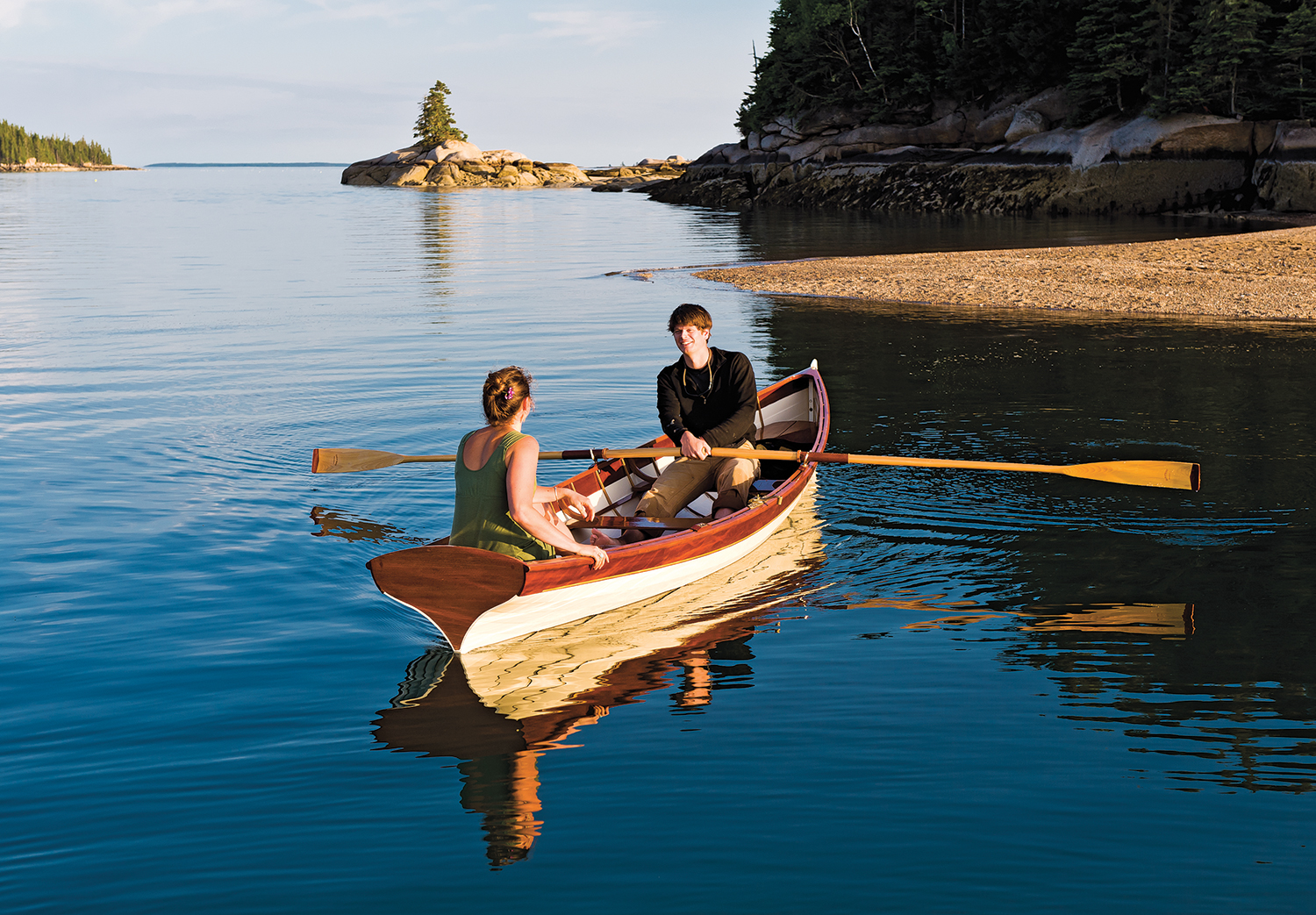 Image of Woman sitting on a bench overlooking Rick's Boat Yard