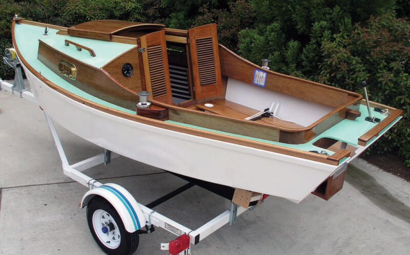 White boat with natural wood trim on a white trailer.