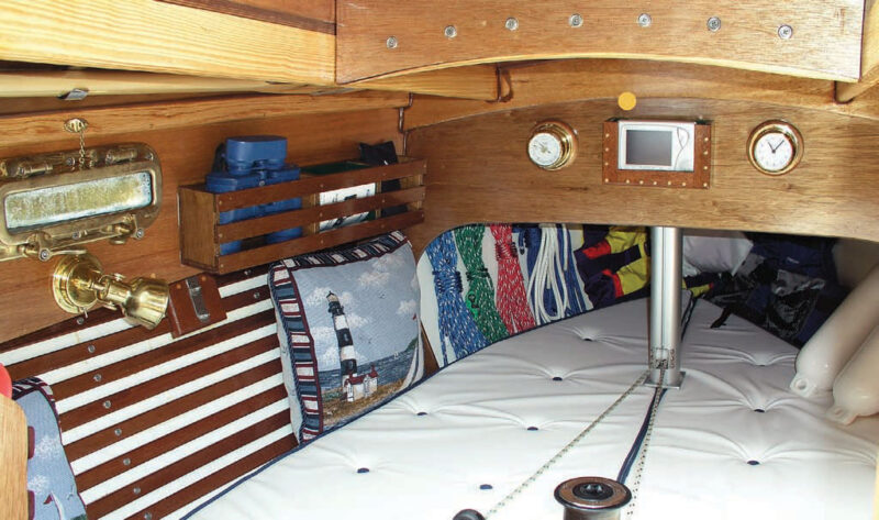 Boat interior with lights, mattress, pillows, barometer and clock.