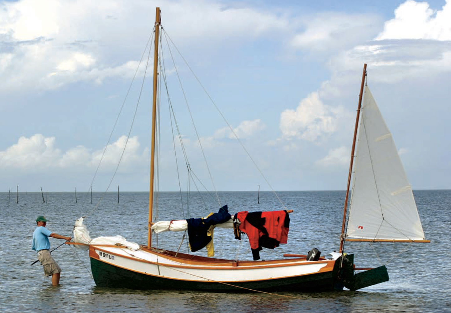 Man prepares a Pathfinder yawl for sailing.