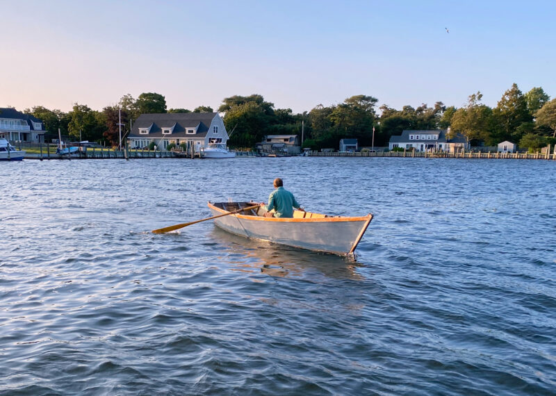 Boater rows a United Nations Flat-Bottomed Skiff.