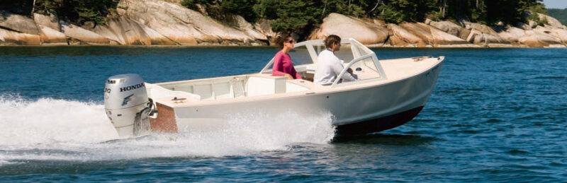 Man and woman ride an Albury runabout powerboat.