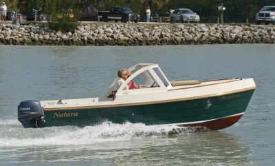 Man and woman riding in a Bay Pilot 18 powerboat.