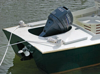 Yamaha motor sits in exposed well at rear of a powerboat.