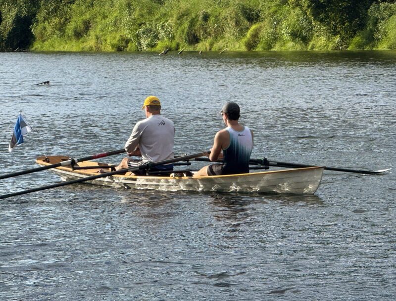 Tow rowers in Annapolis Wherry Tandem, viewed from starboard bow 