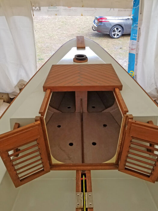 White-painted foredeck with teak cabin companionway