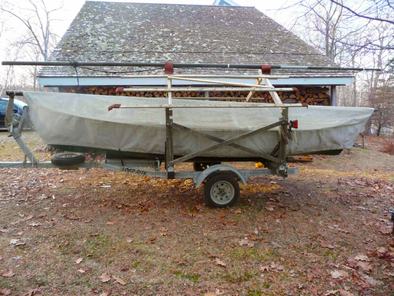 Small covered boat on trailer ready for winterizing