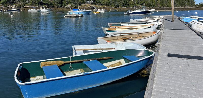 A variety of small boats tied to a dock