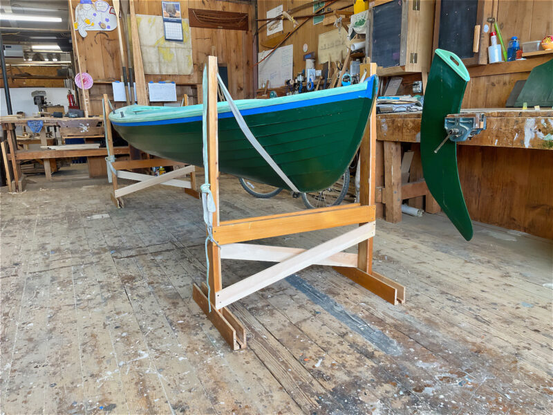 Traditional wooden boat suspended in home-made H-stands with slings