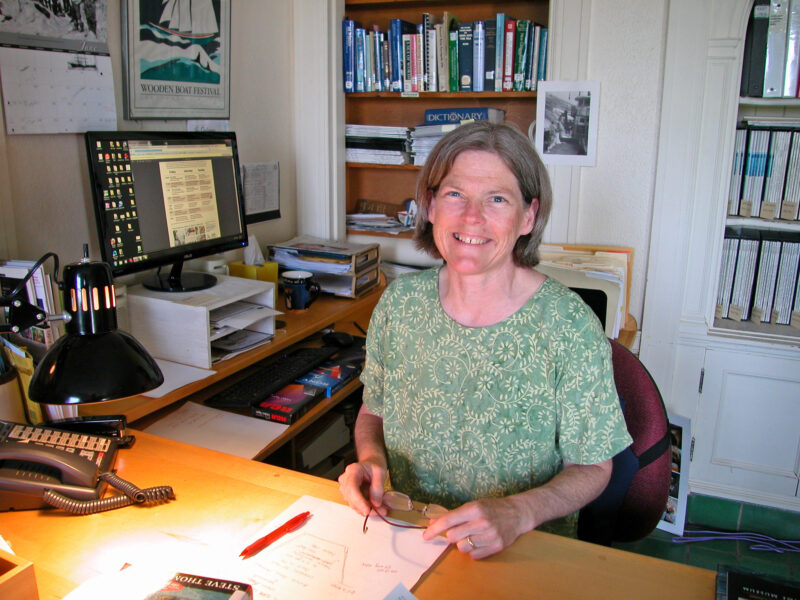 Pat Lown at her desk in WoodenBoat's library